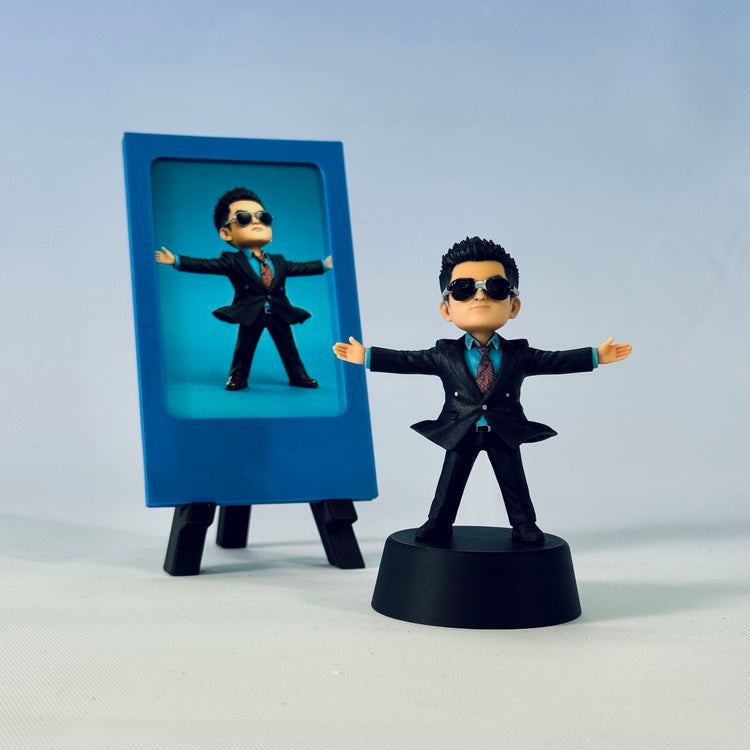 Finished arms-wide custom boss figure in a black suit beside a blue simple photo frame