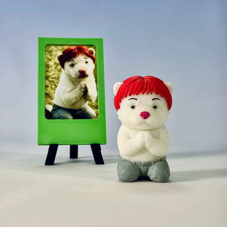 Finished white dog custom figure beside a green simple photo frame, preserving the red hair and clasped-paw pose