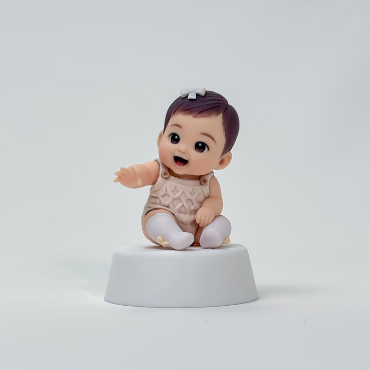 Close finished view of the seated baby custom figure with a reaching hand and bow socks