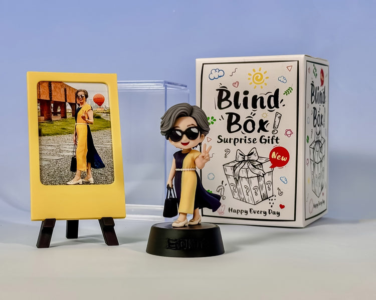 Finished travel figure with a simple yellow photo frame, clear protective case, and basic packaging